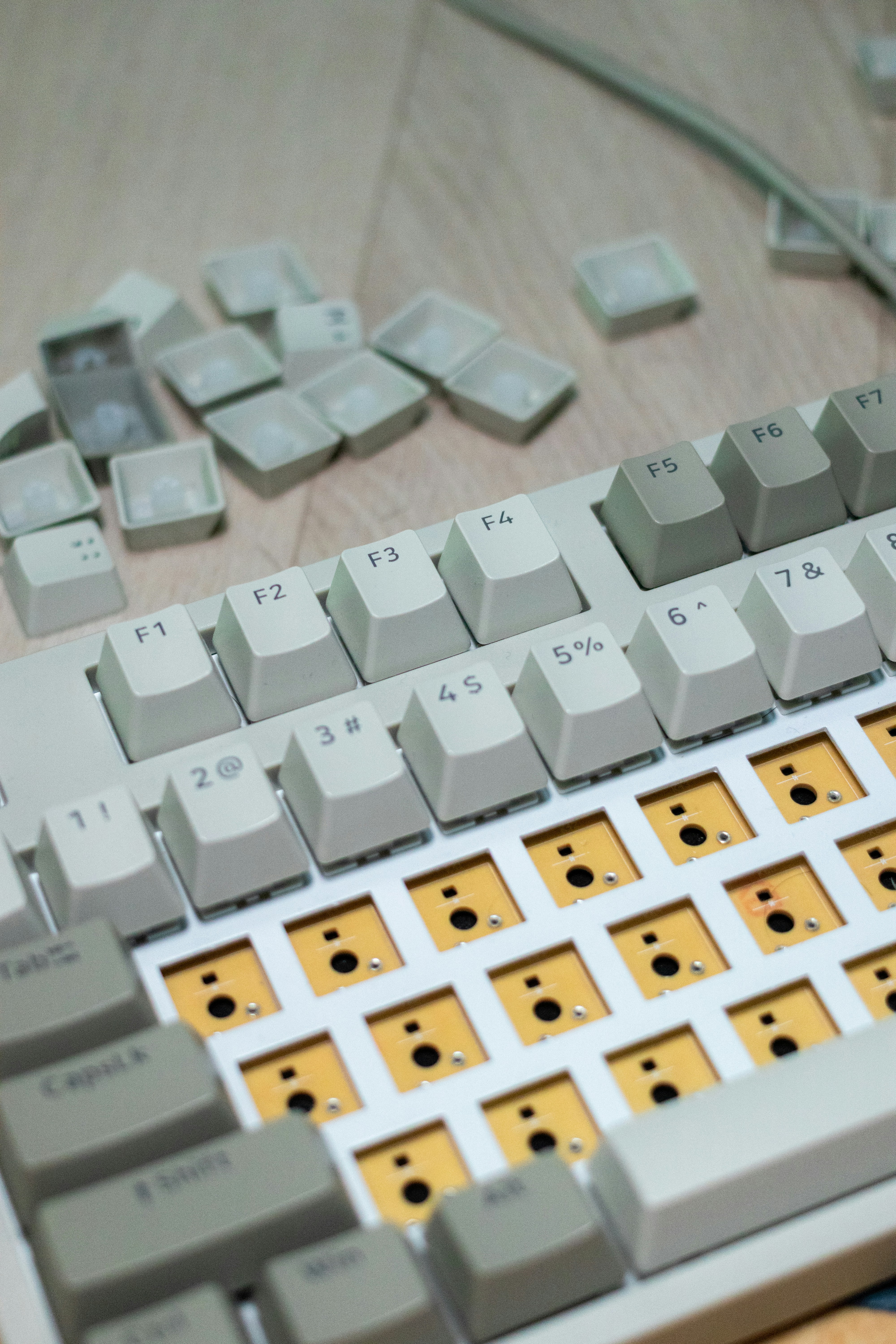 A computer keyboard sitting on top of a wooden table