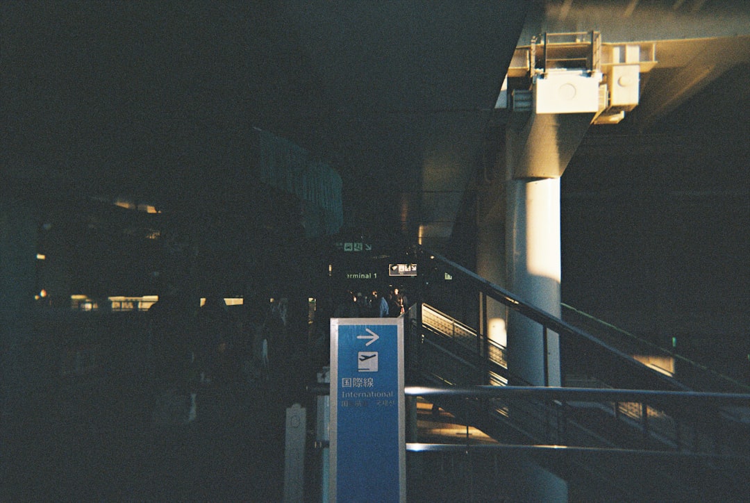 A blue sign sitting next to a set of stairs,
