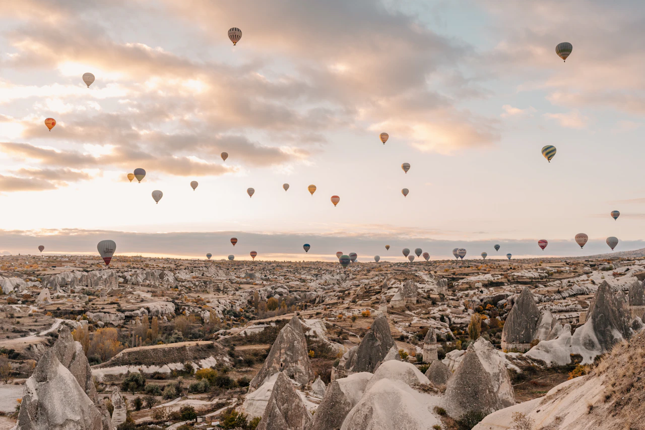 Cappadocia’s rocky valleys with hot air balloons overhead