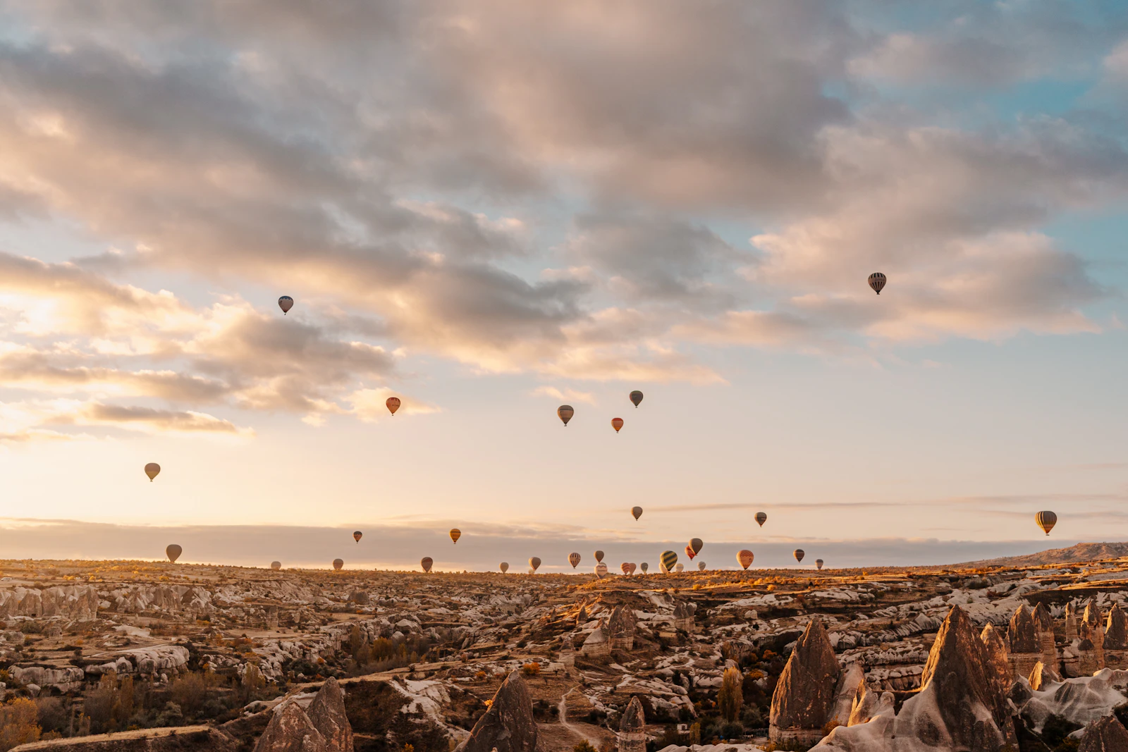 Hot air balloons rising over Göreme in Cappadocia at sunrise