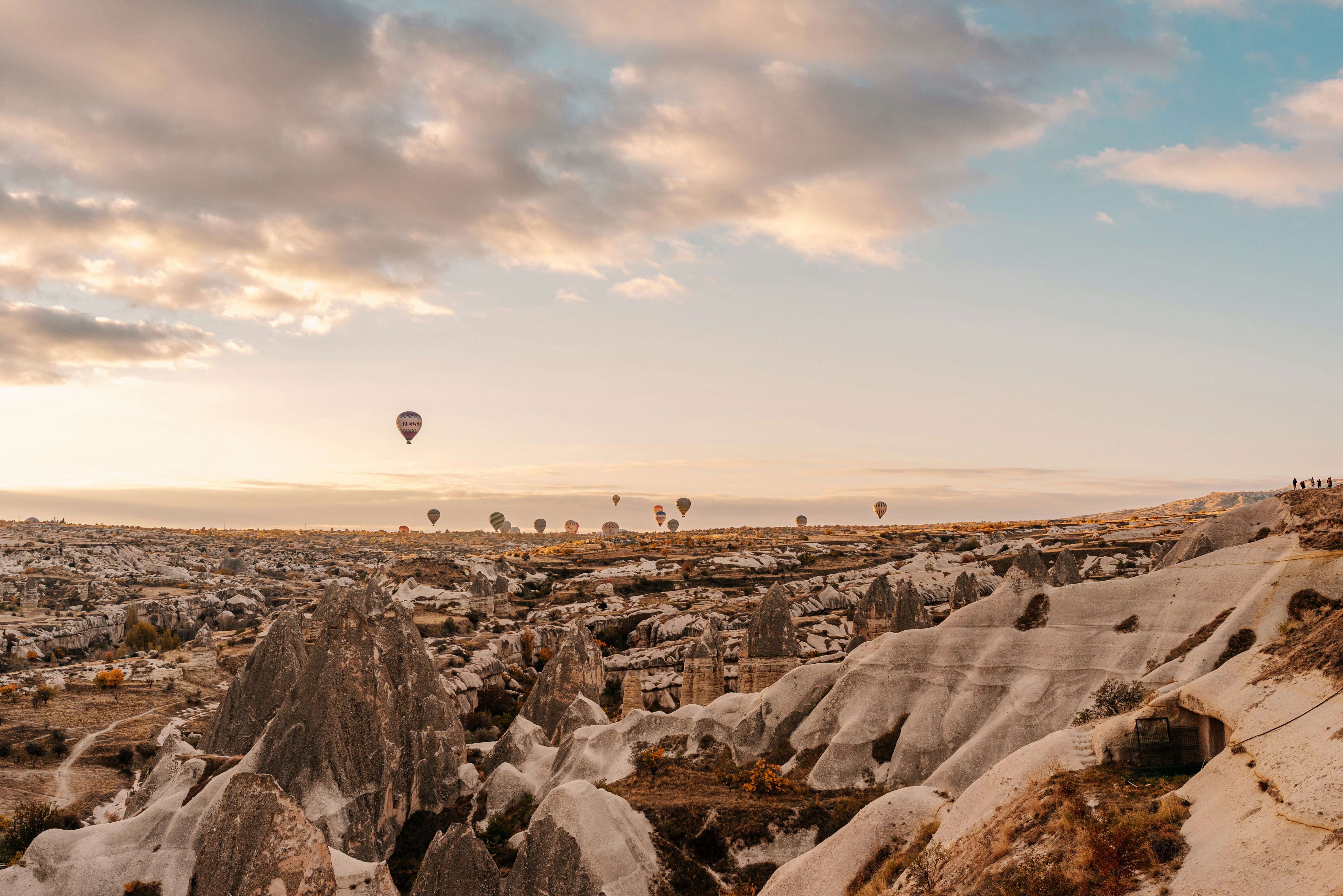 A hot air balloon flying over a rocky landscape