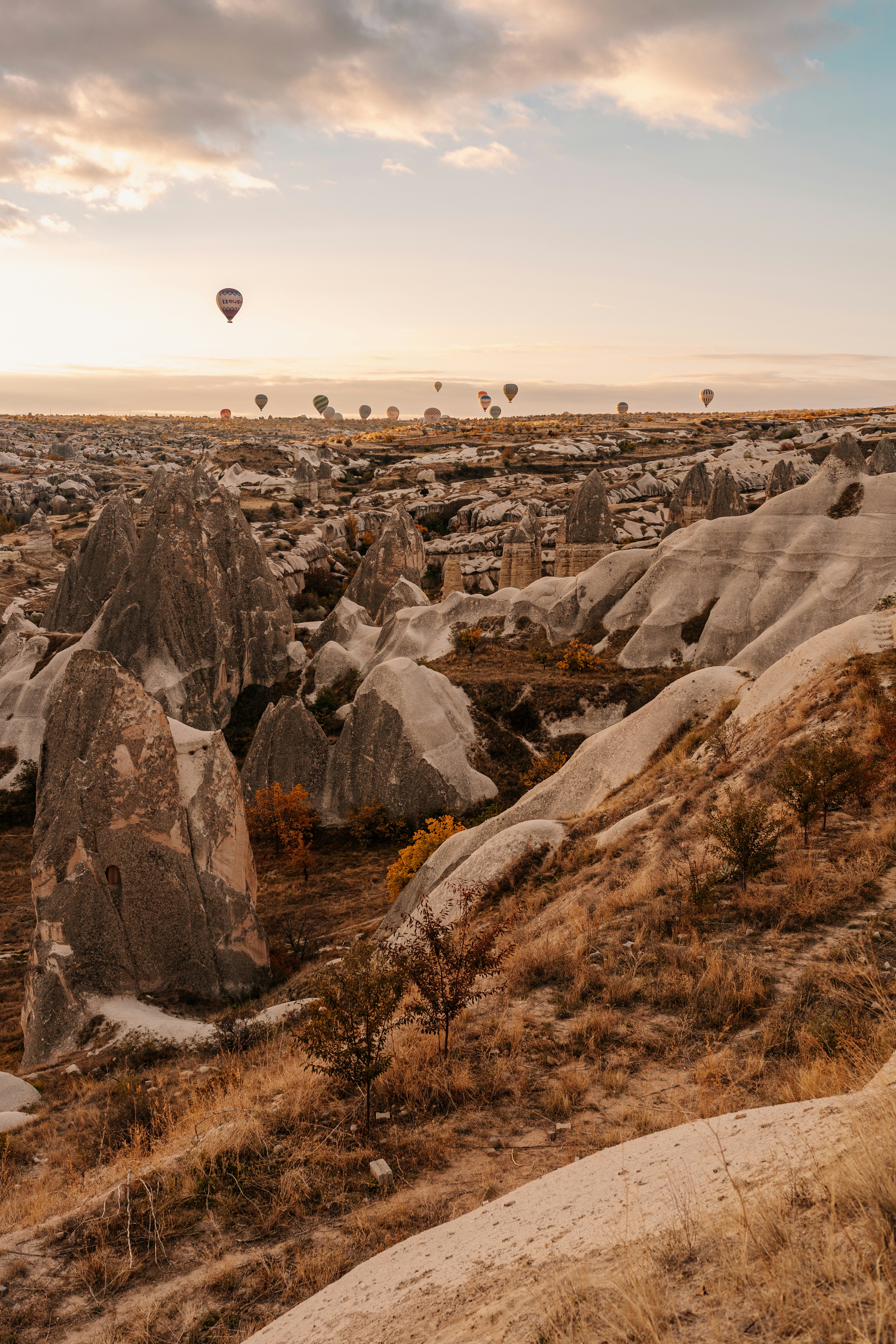 A hot air balloon flying over a rocky landscape