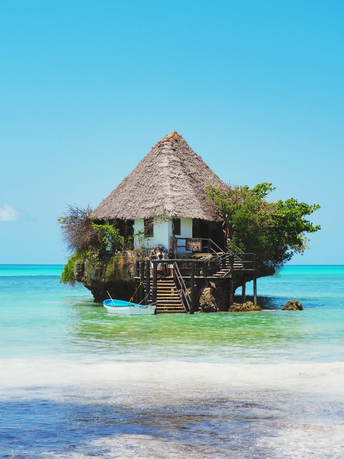 A restaurant on a rock surrounded by sea