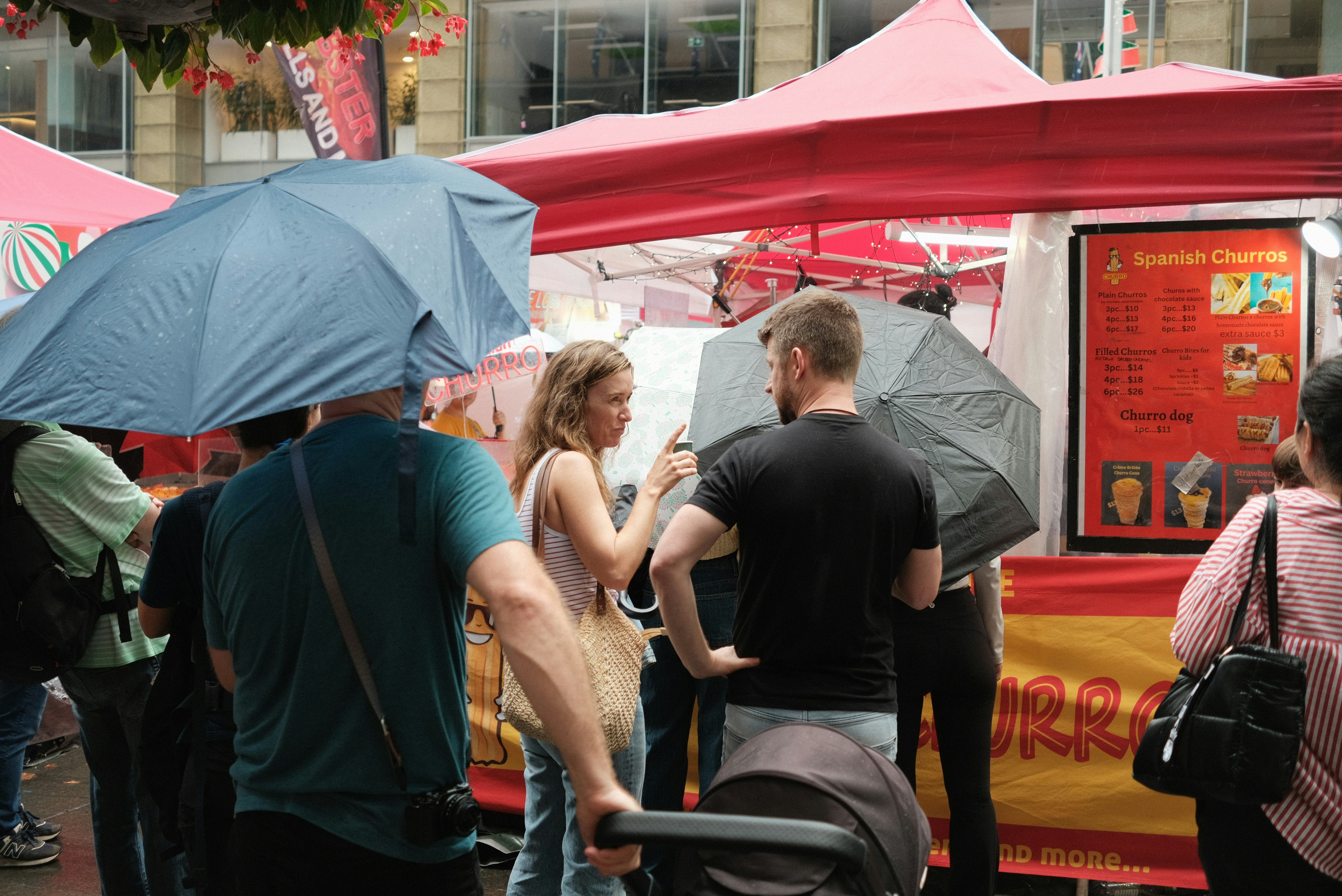 A group of people standing around a food truck