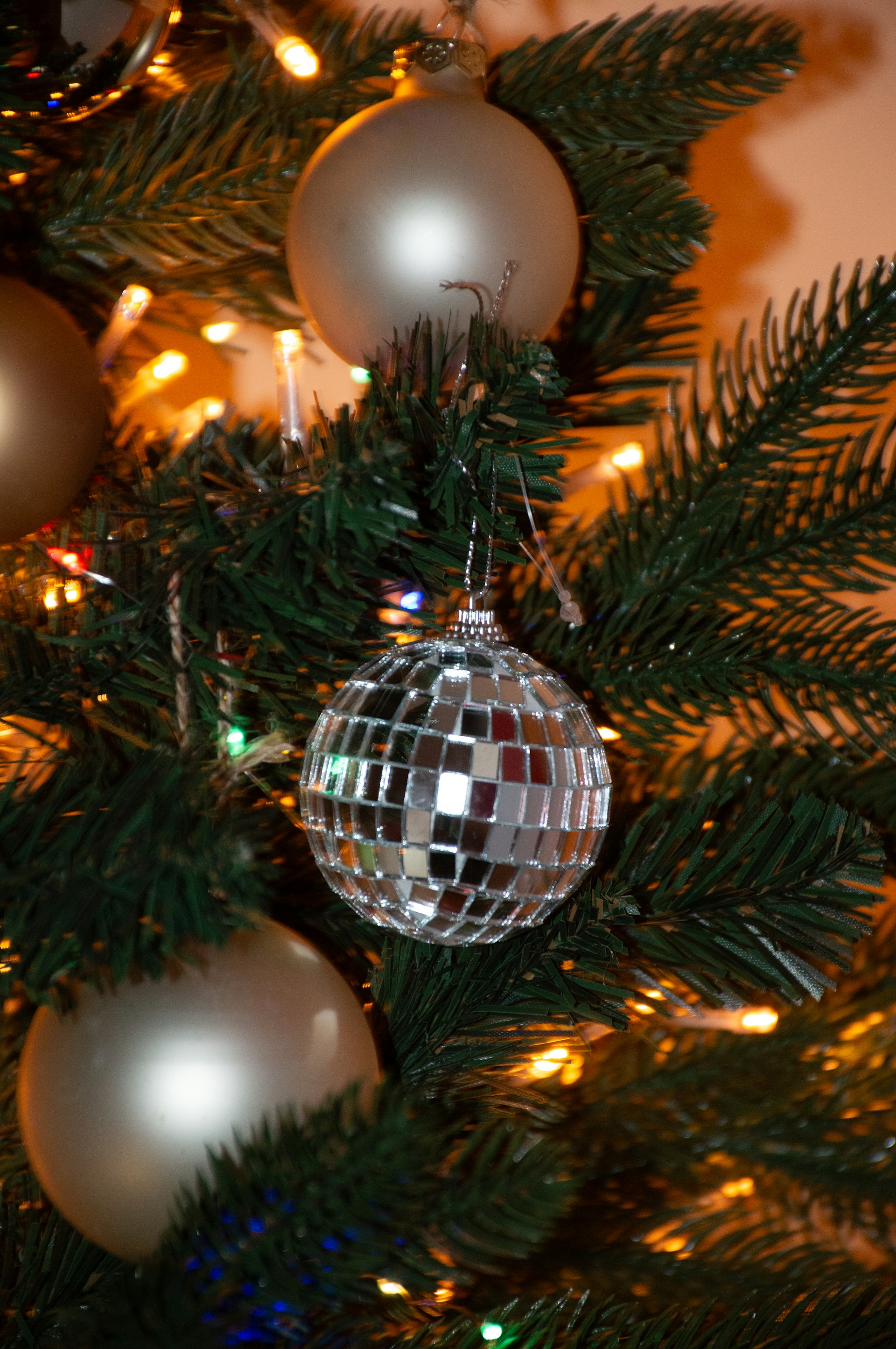 A christmas tree with a disco ball ornament on it