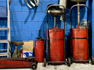 A bunch of red luggage sitting next to a blue wall