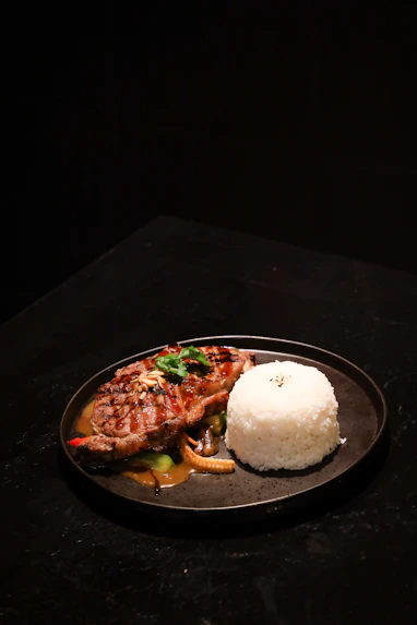 A plate of food with rice and meat