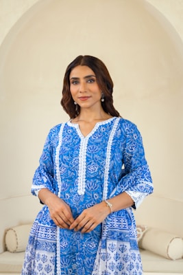 A woman standing in front of a white couch