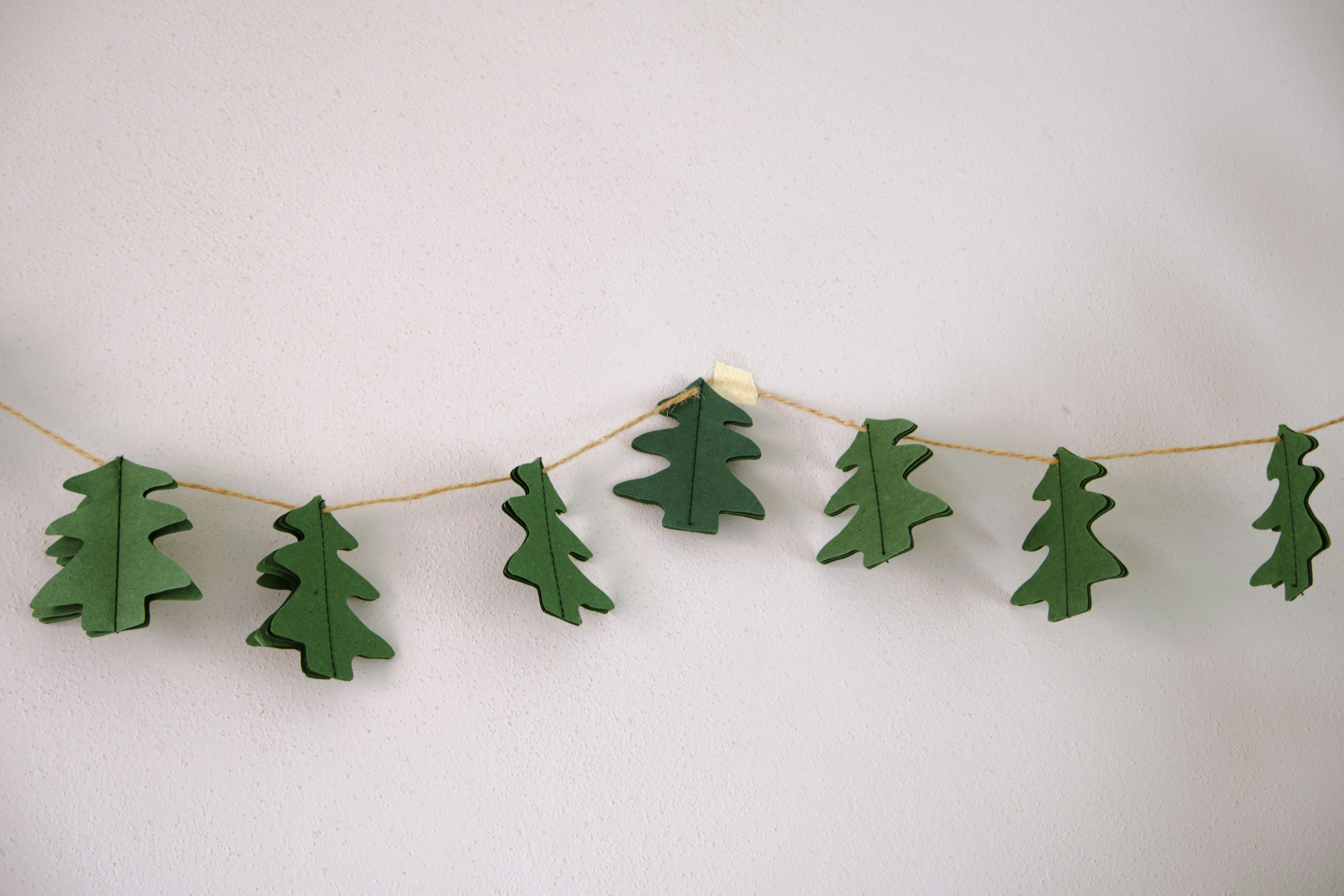 Finished Christmas crafts flat lay including tags, garlands, and 3D paper trees