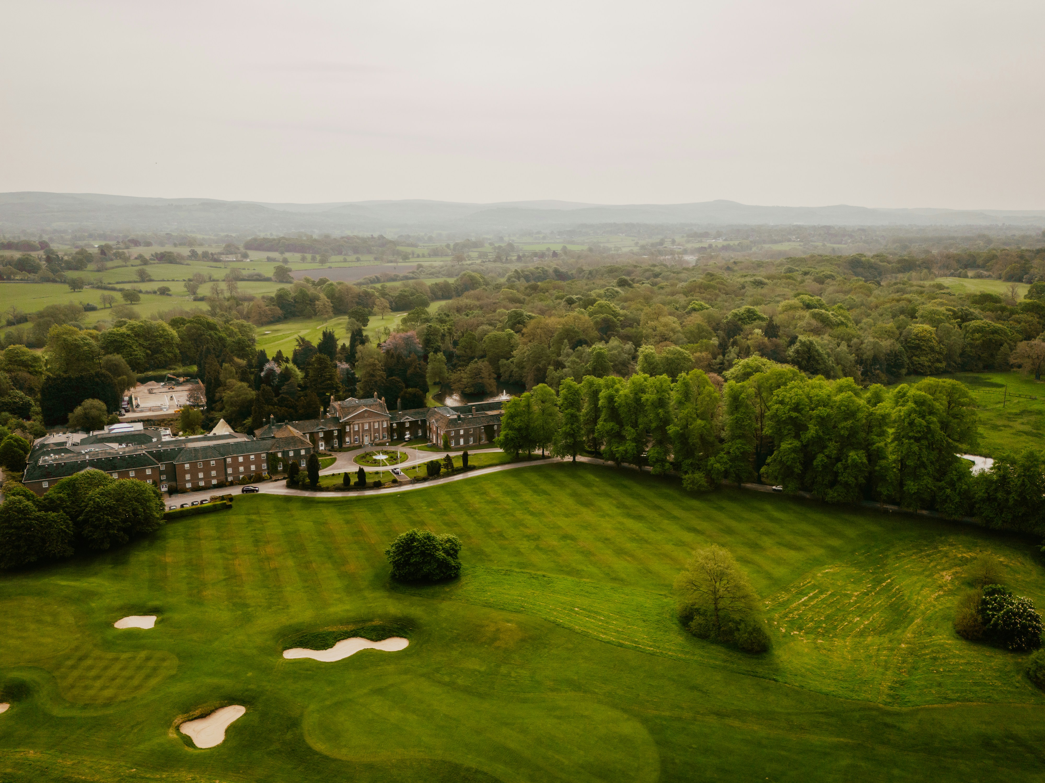 An aerial view of a golf course in the distance
