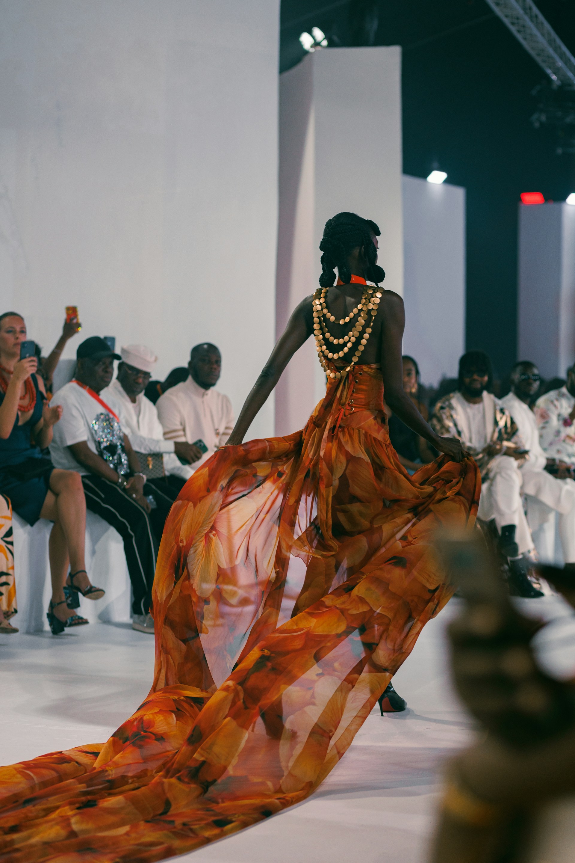 A woman walking down a runway in a dress