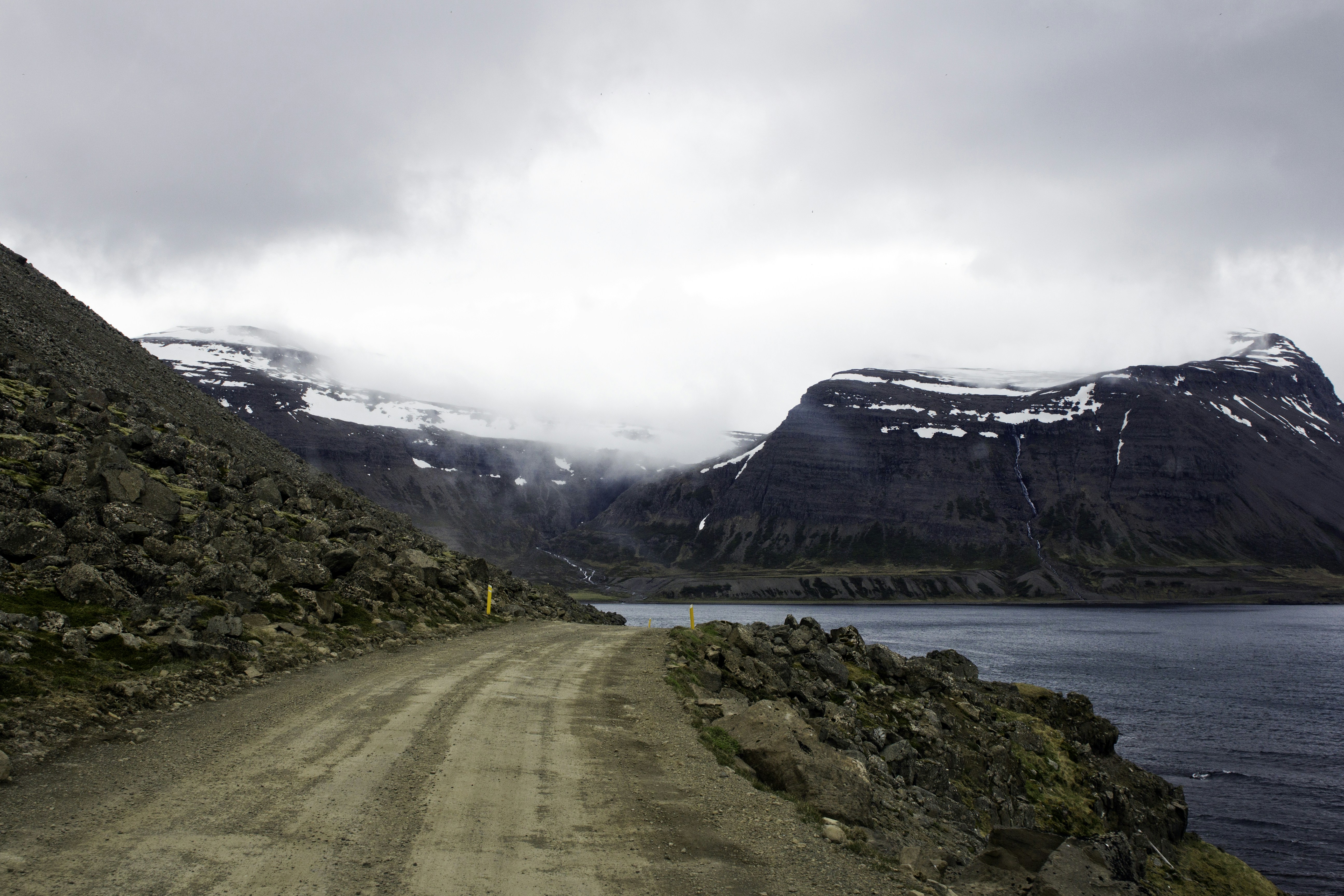 A dirt road near a body of water