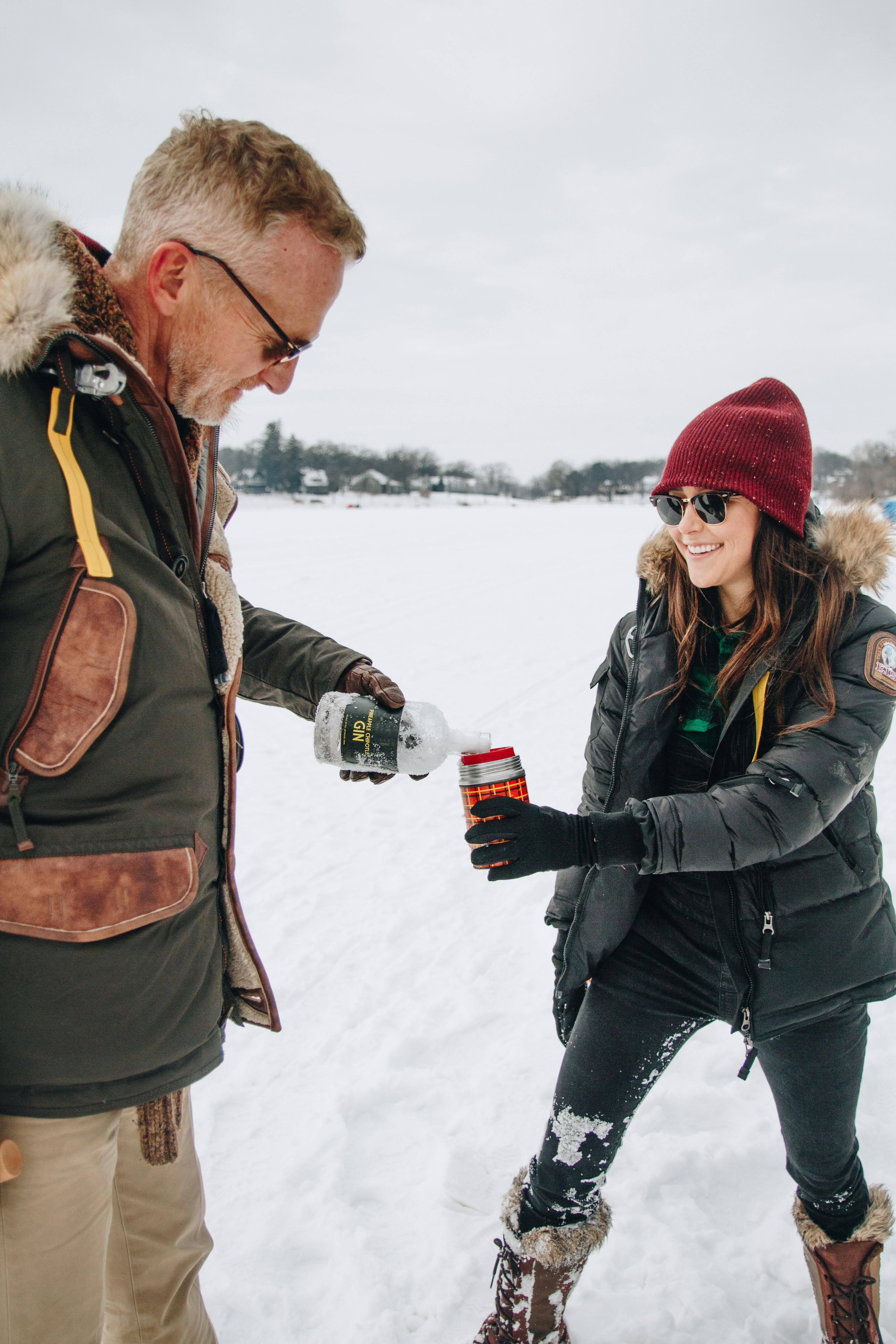 A man and a woman standing in the snow