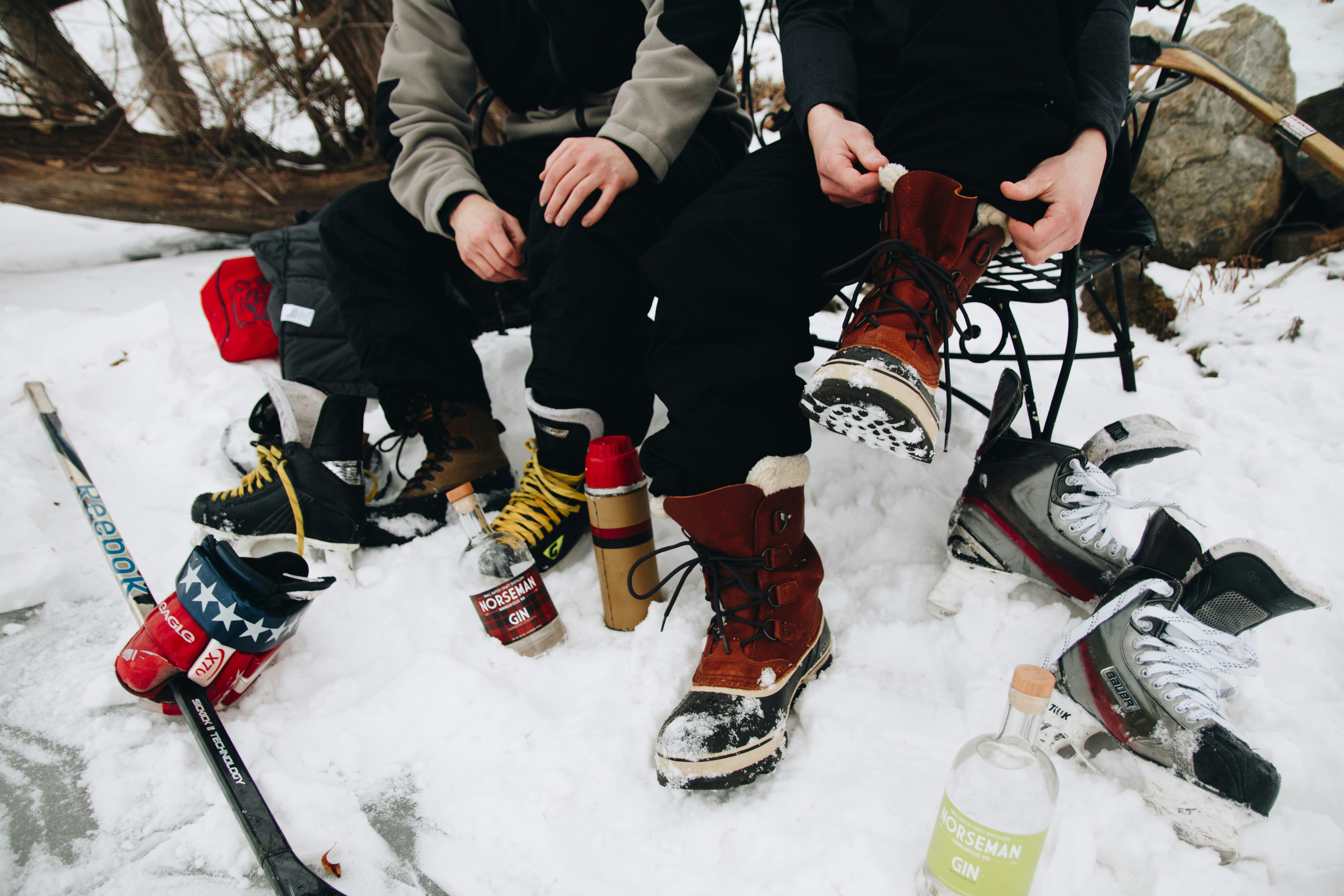 A couple of people sitting on top of a pile of snow