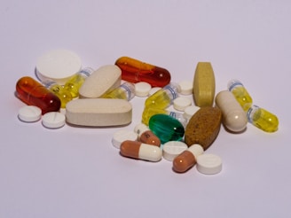 A pile of pills sitting on top of a white table