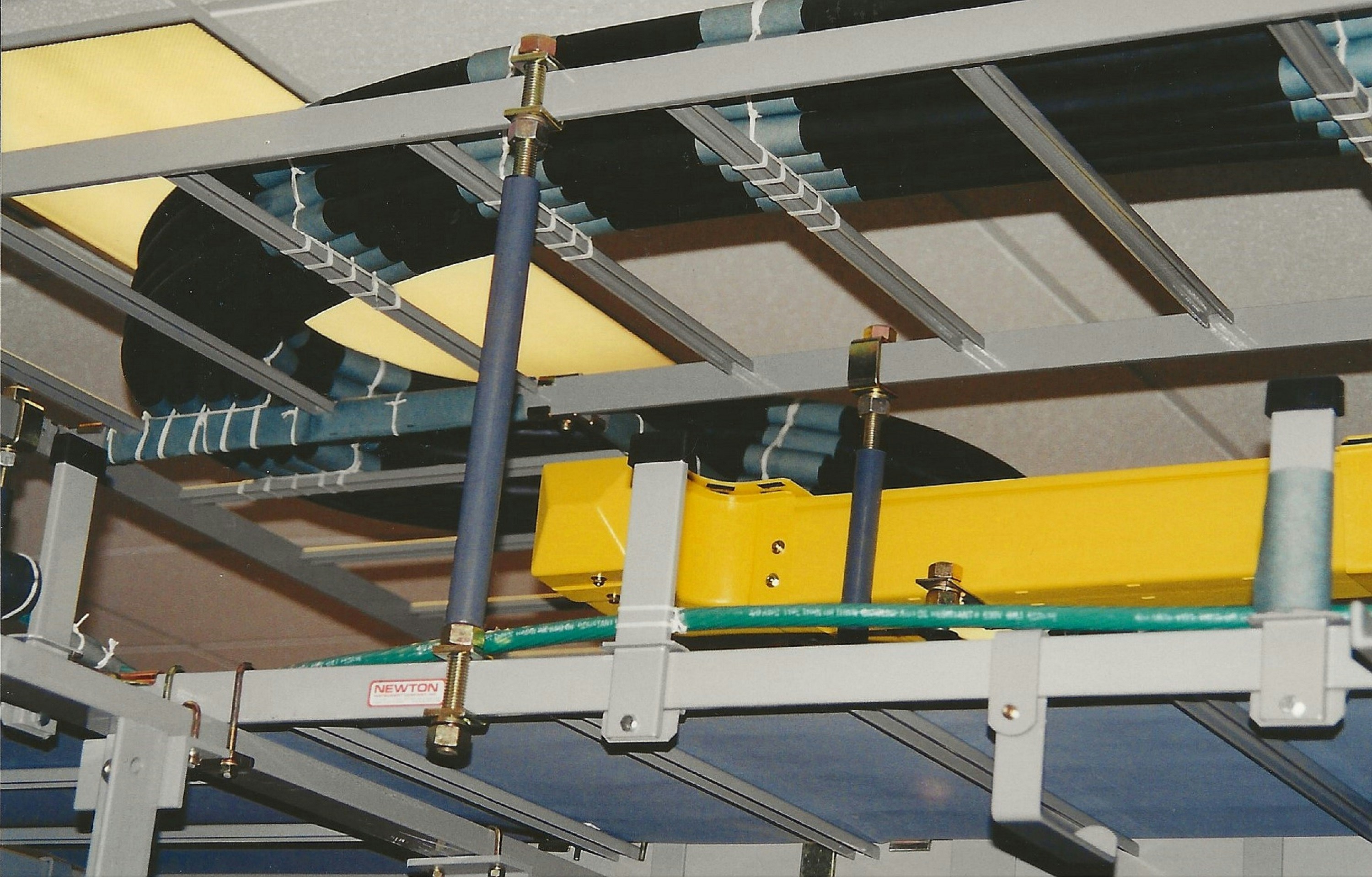 A yellow surfboard hanging from the ceiling of a building