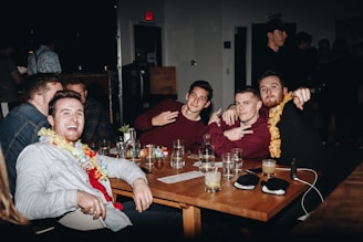 A group of men sitting around a wooden table