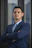 A man in a suit standing with his arms crossed