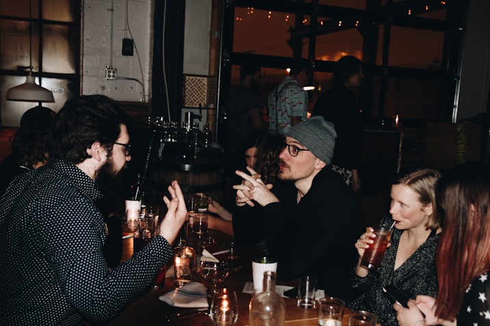 A group of people sitting around a table talking