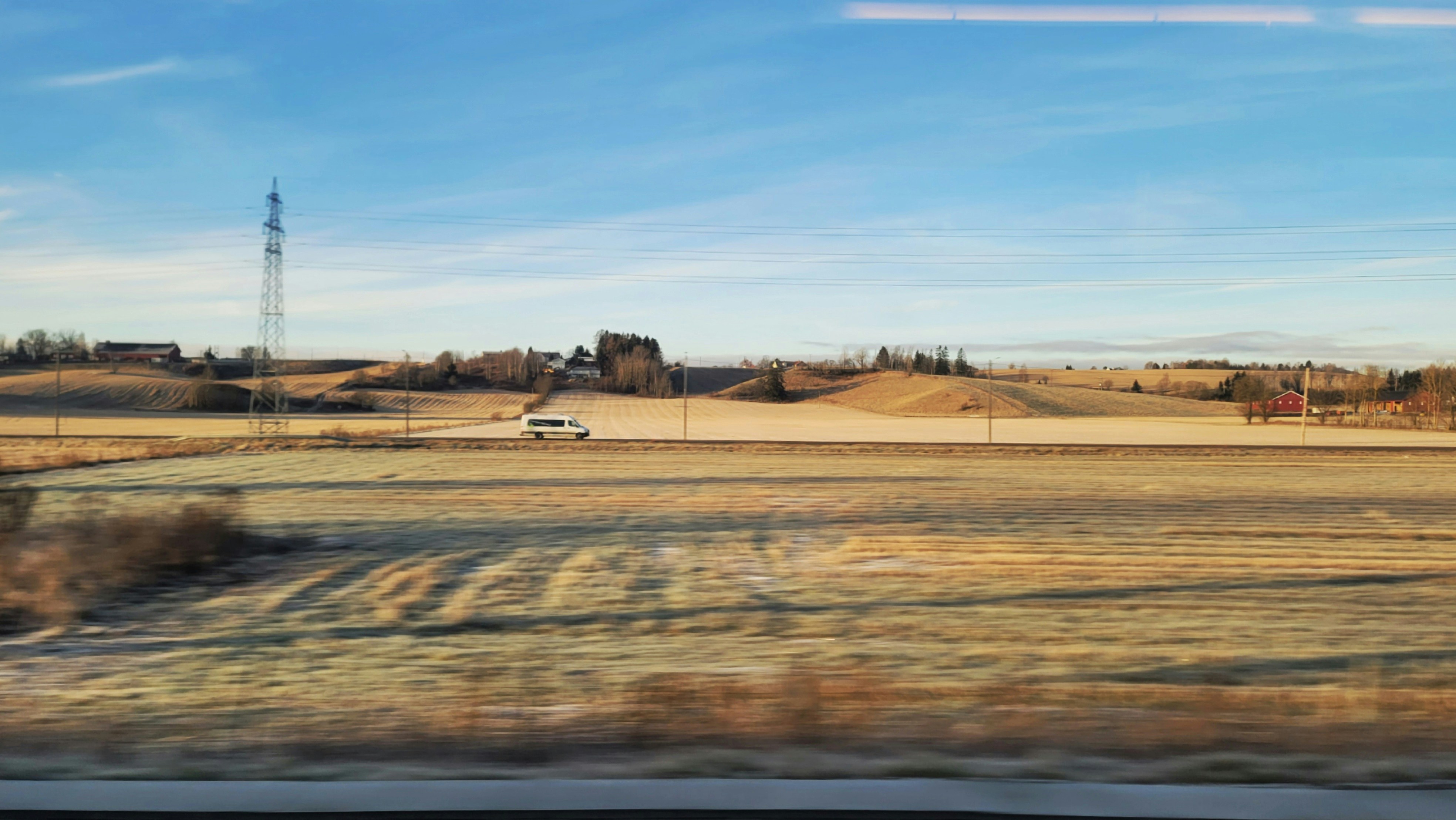 A view of a field from a train window