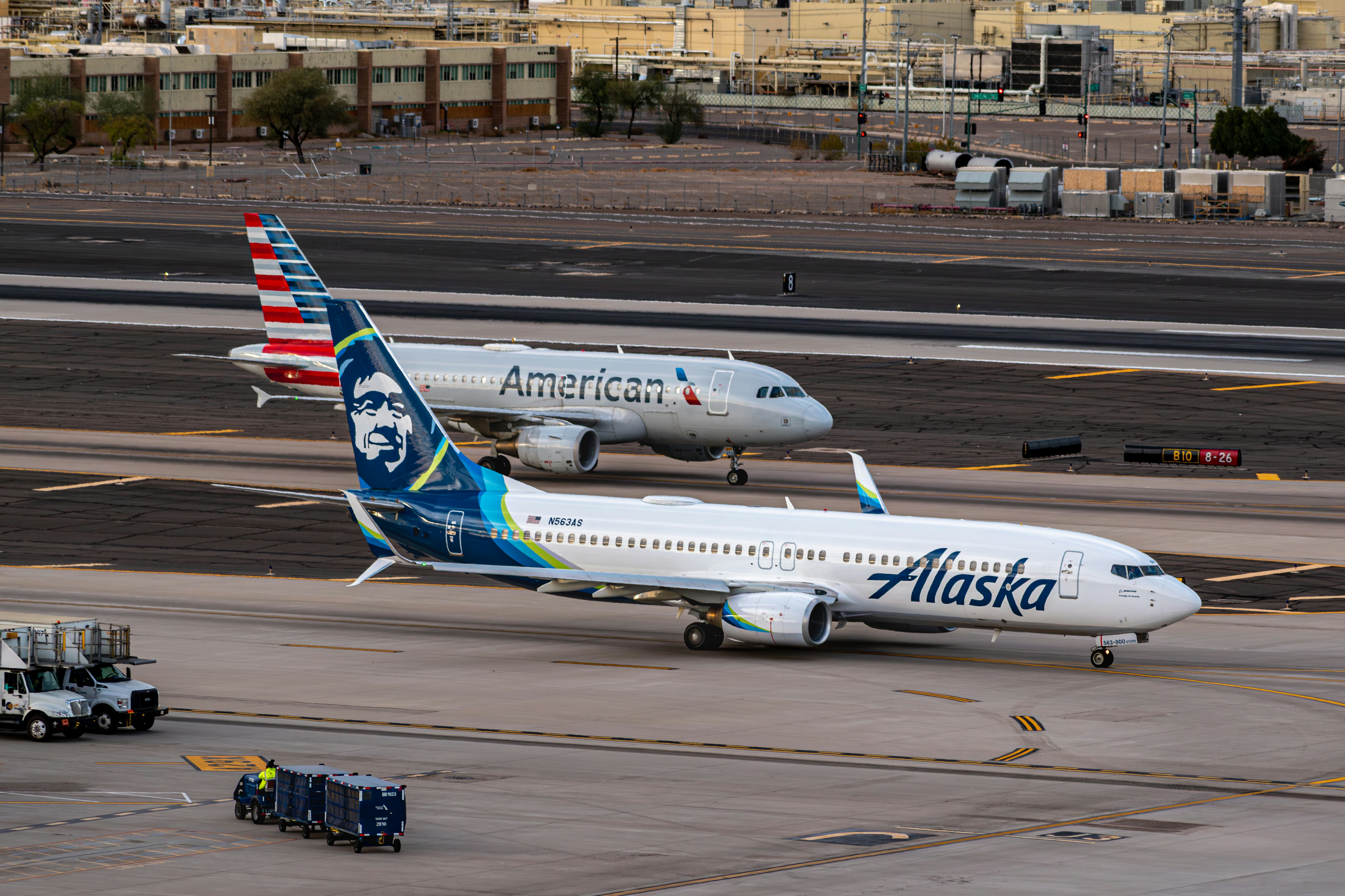 A couple of airplanes that are on a runway