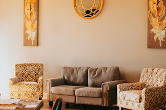 A living room with two chairs and a couch