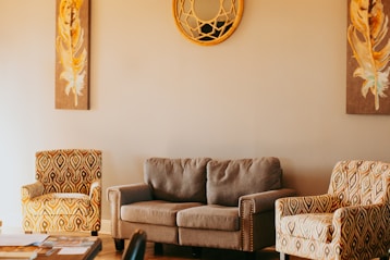 A living room with two chairs and a couch
