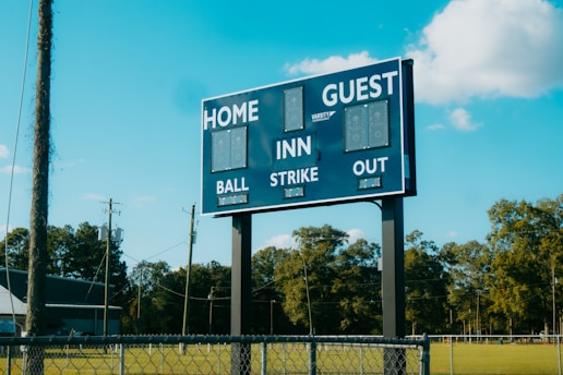 A baseball field with a large sign on it