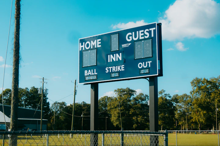 A baseball field with a large sign on it