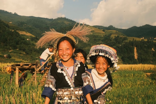 A group of people standing on top of a lush green field