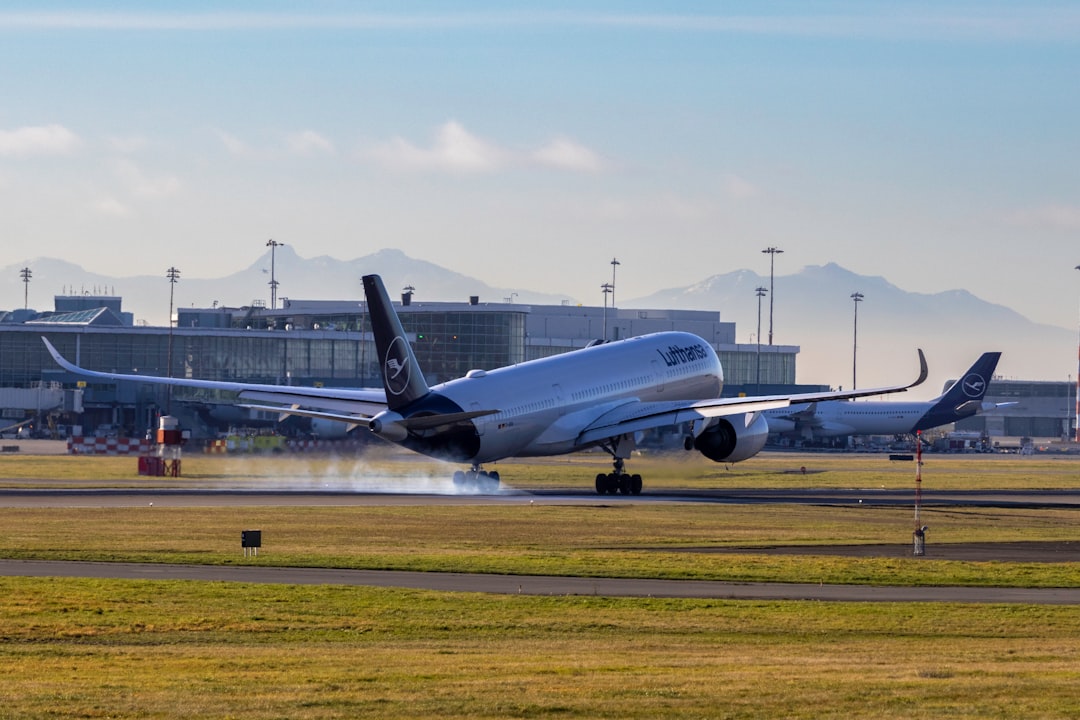 A large jetliner taking off from an airport runway, Lufthansa Airbus A350-900 landing at YVR - Vancouver Airport on a bright sunny day.