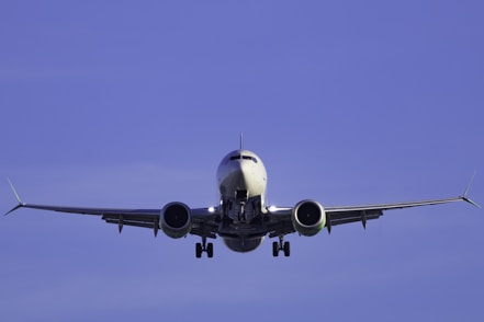A large jetliner flying through a blue sky