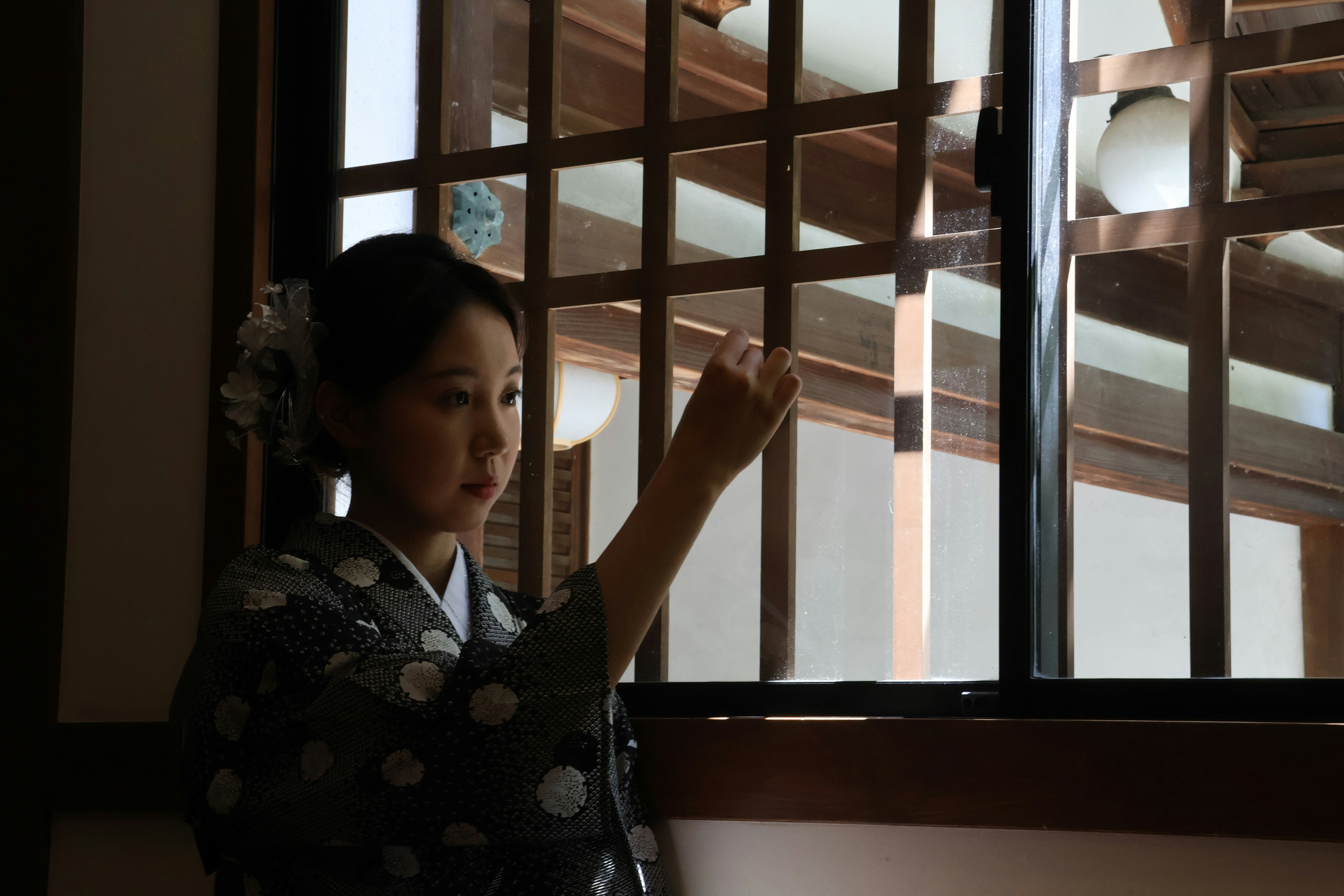 Japanese woman politely declining a drink refill with a hand gesture and a smile