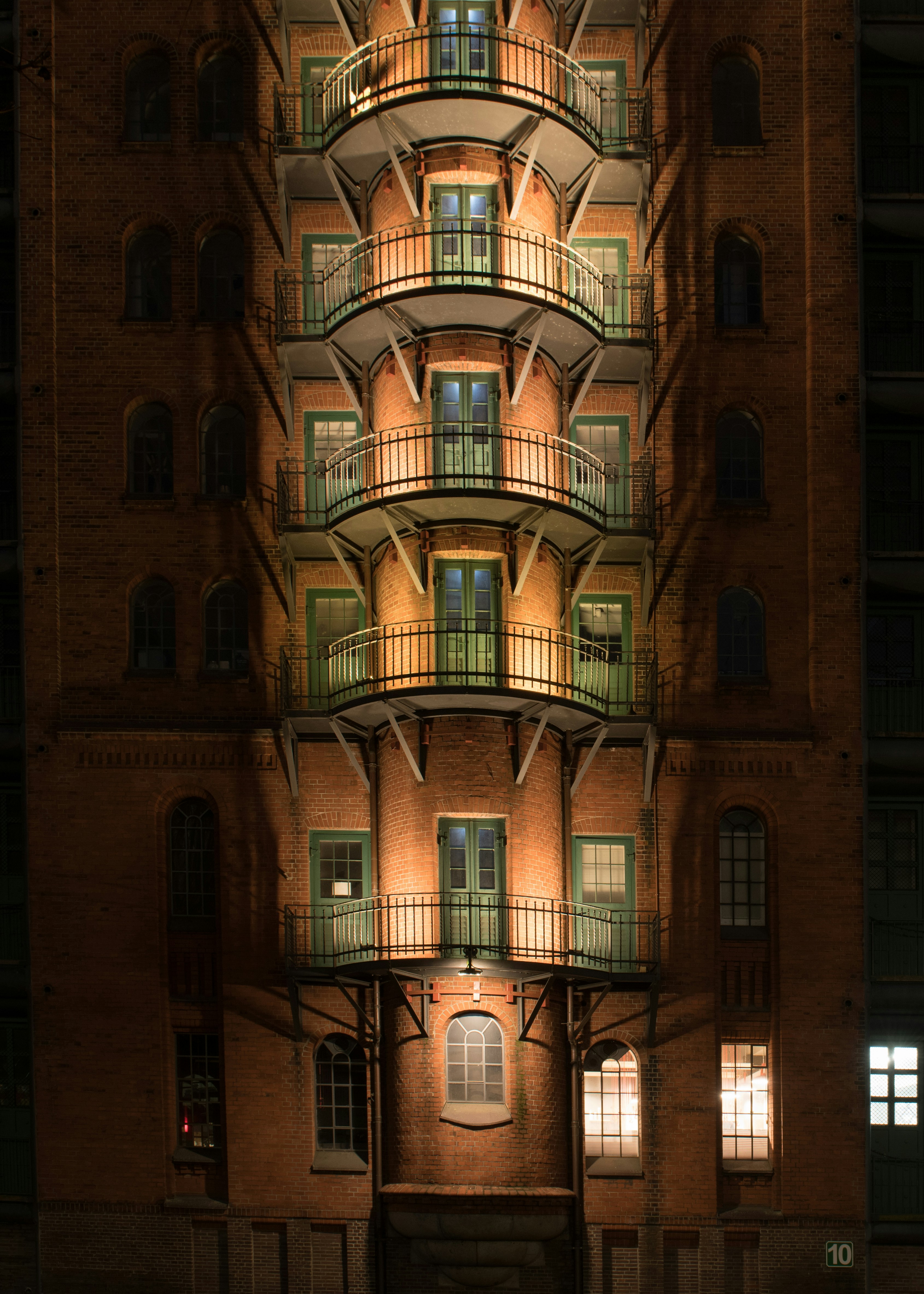 A tall building lit up at night with windows