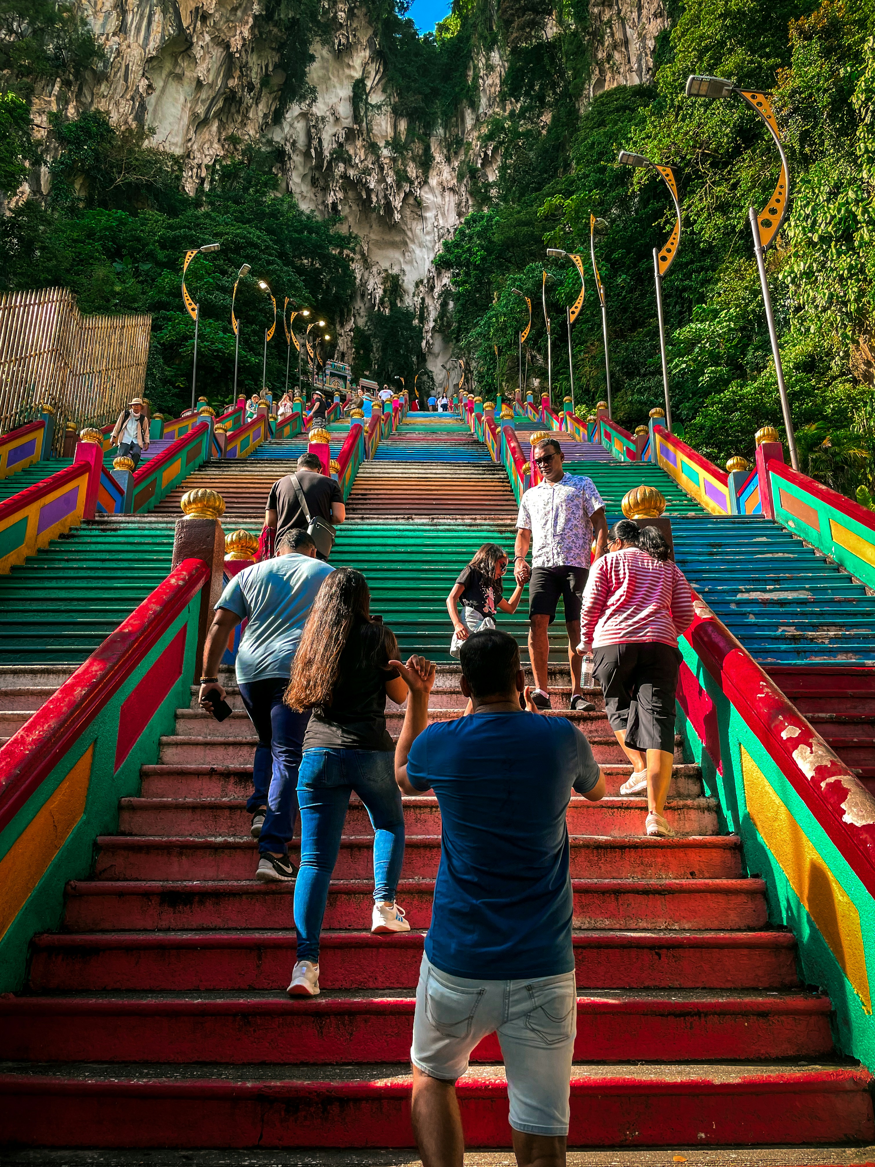 A group of people walking up some stairs