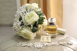 A bouquet of flowers sitting on top of a ottoman