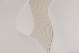 A close up of a white vase with wavy lines on it