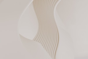 A close up of a white vase with wavy lines on it