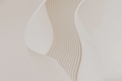 A close up of a white vase with wavy lines on it