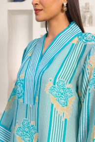 A woman wearing a blue and gold dress