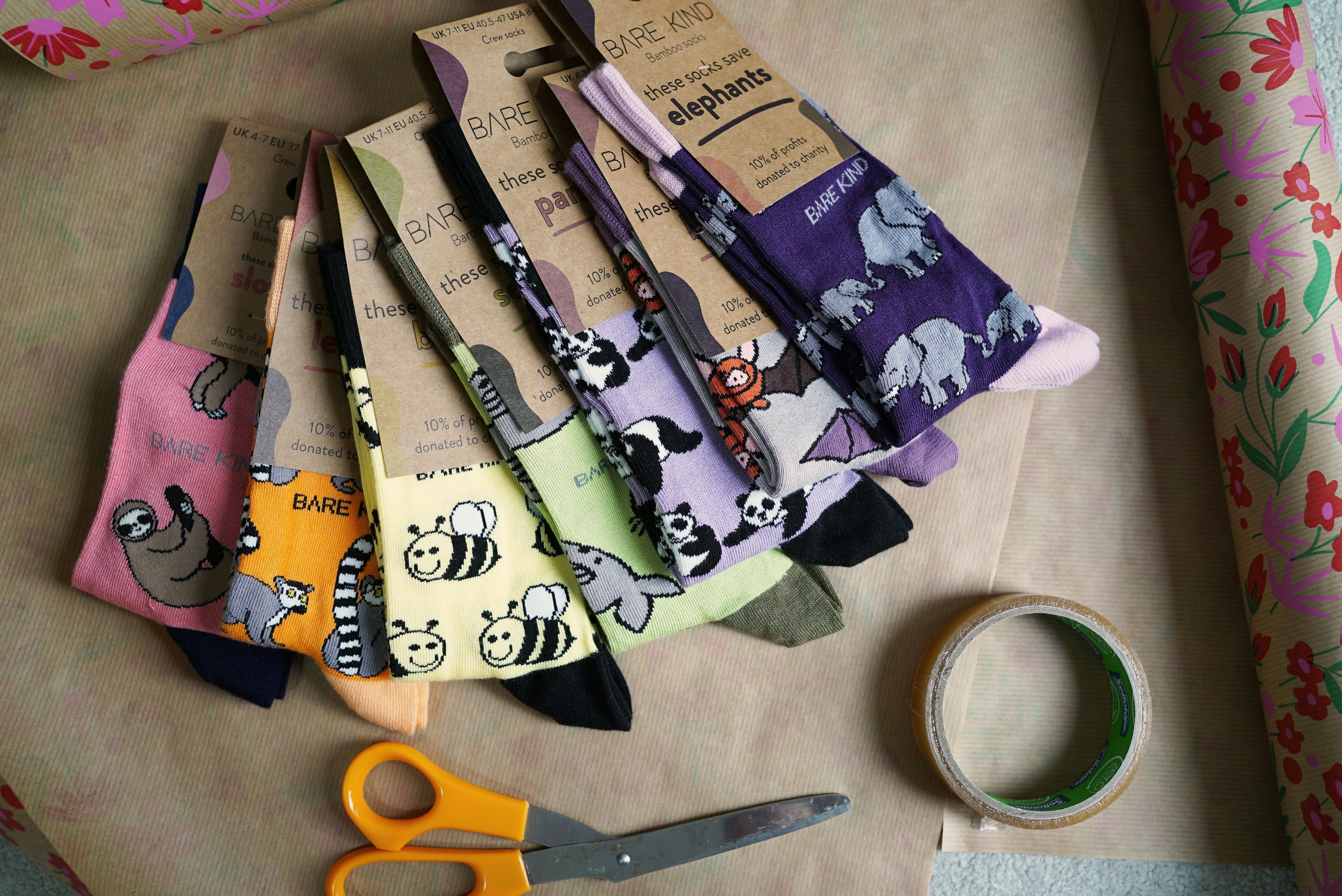 A bunch of scissors and a pair of scissors on a table