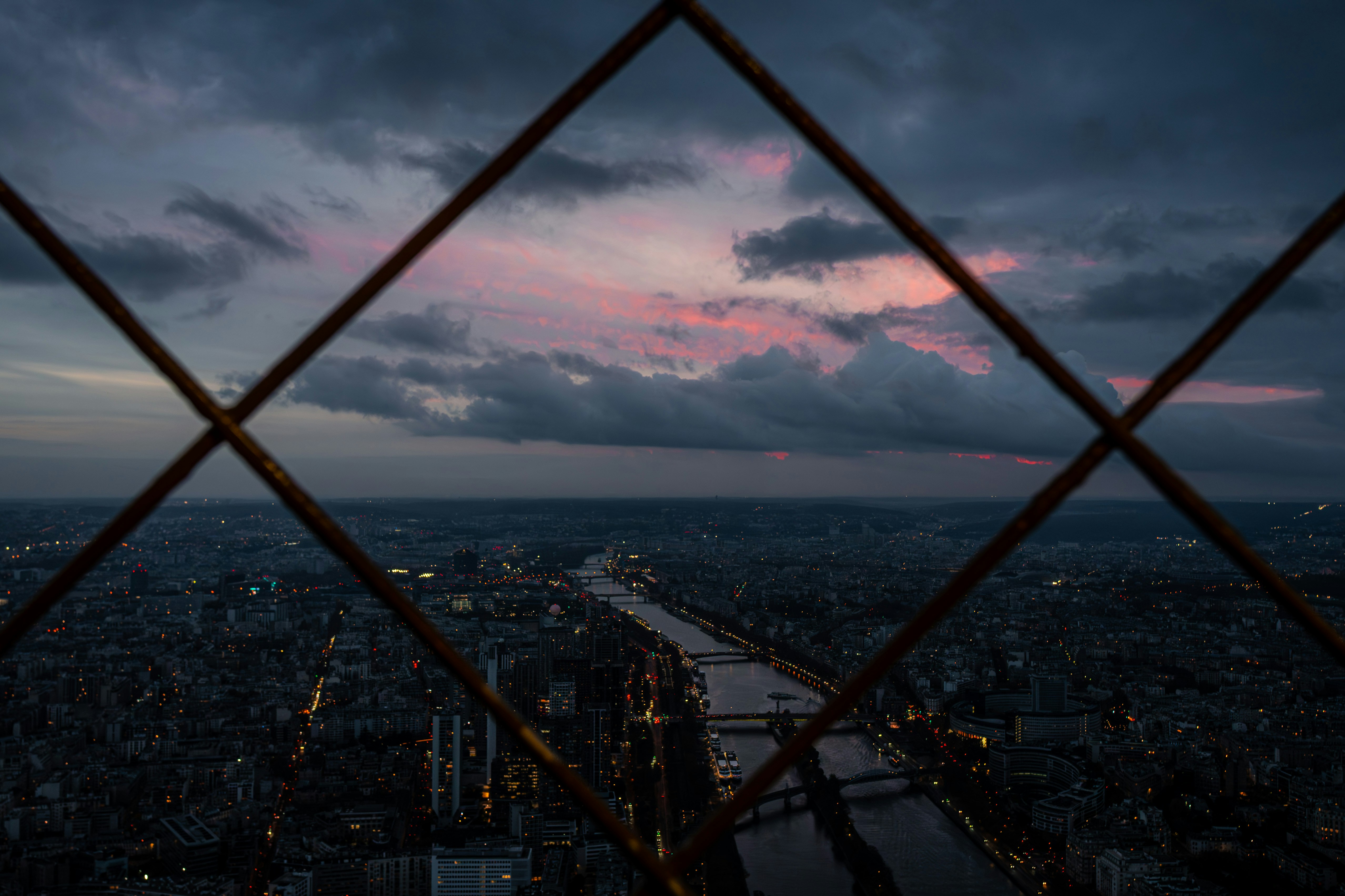 A view of a city through a fence