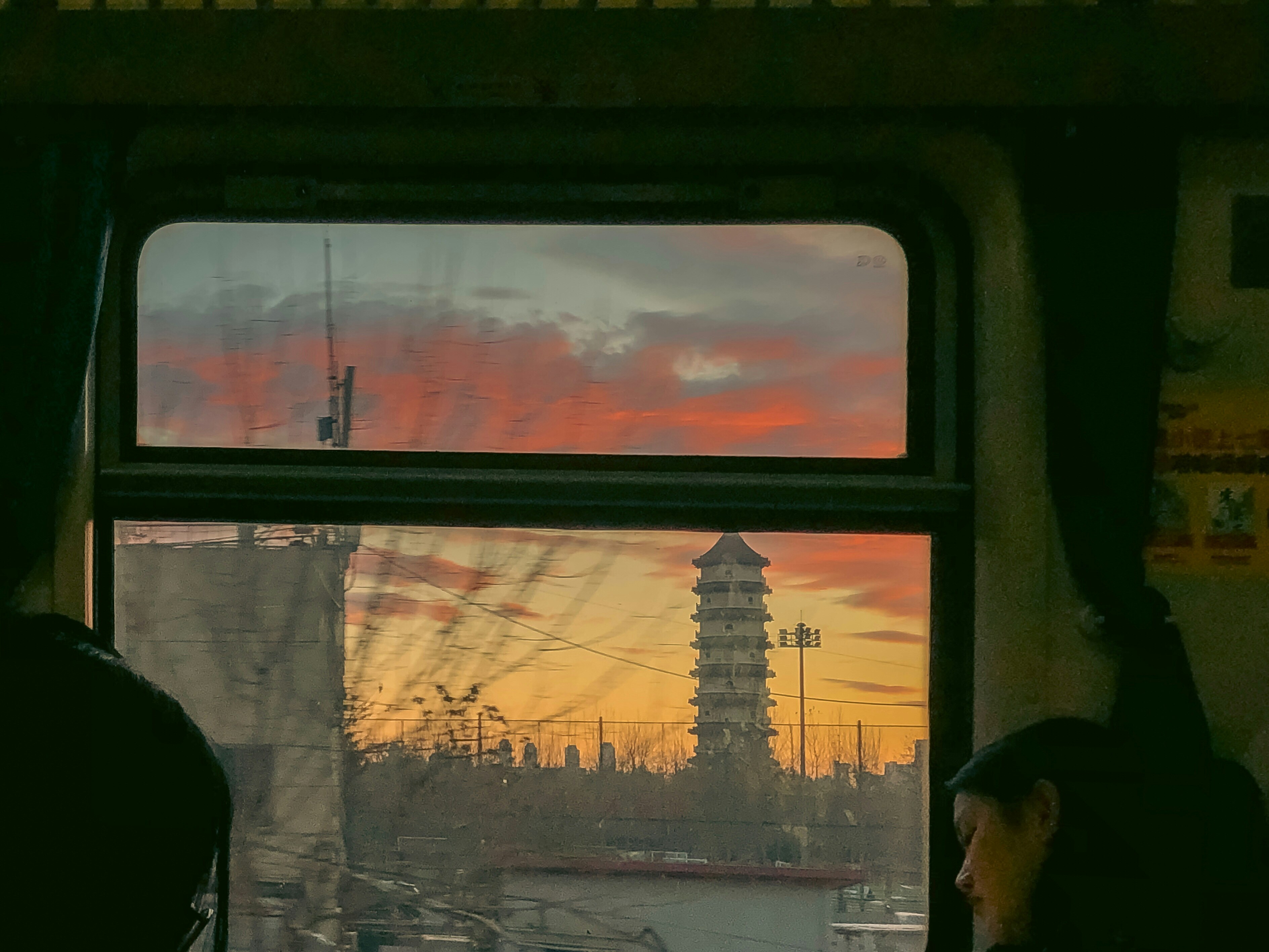 A man sitting on a train looking out a window