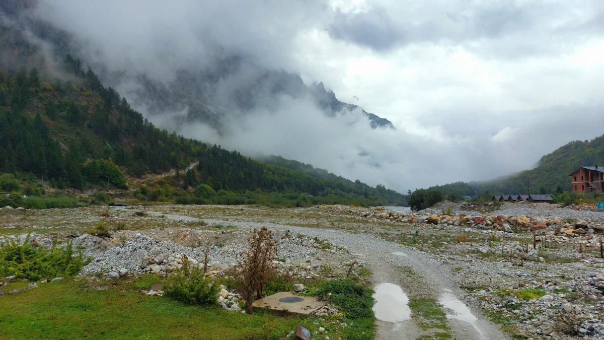 A gravel road winding through a high alpine valley