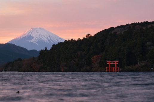 A body of water with a mountain in the background
