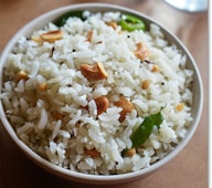 A white bowl filled with rice and nuts