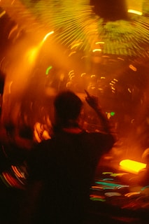 A group of people dancing in a dark room