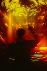 A blurry photo of a person dancing at a concert