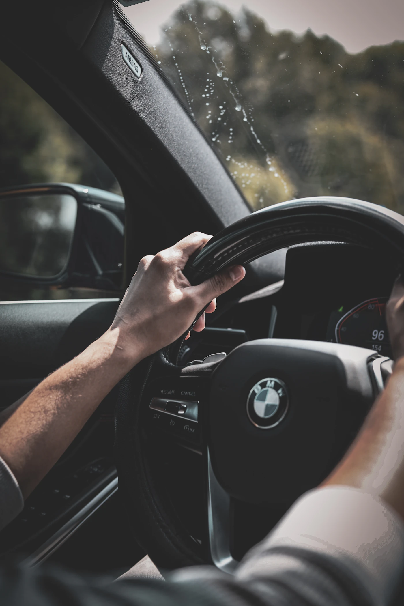 Driver with both hands on the wheel on an open road
