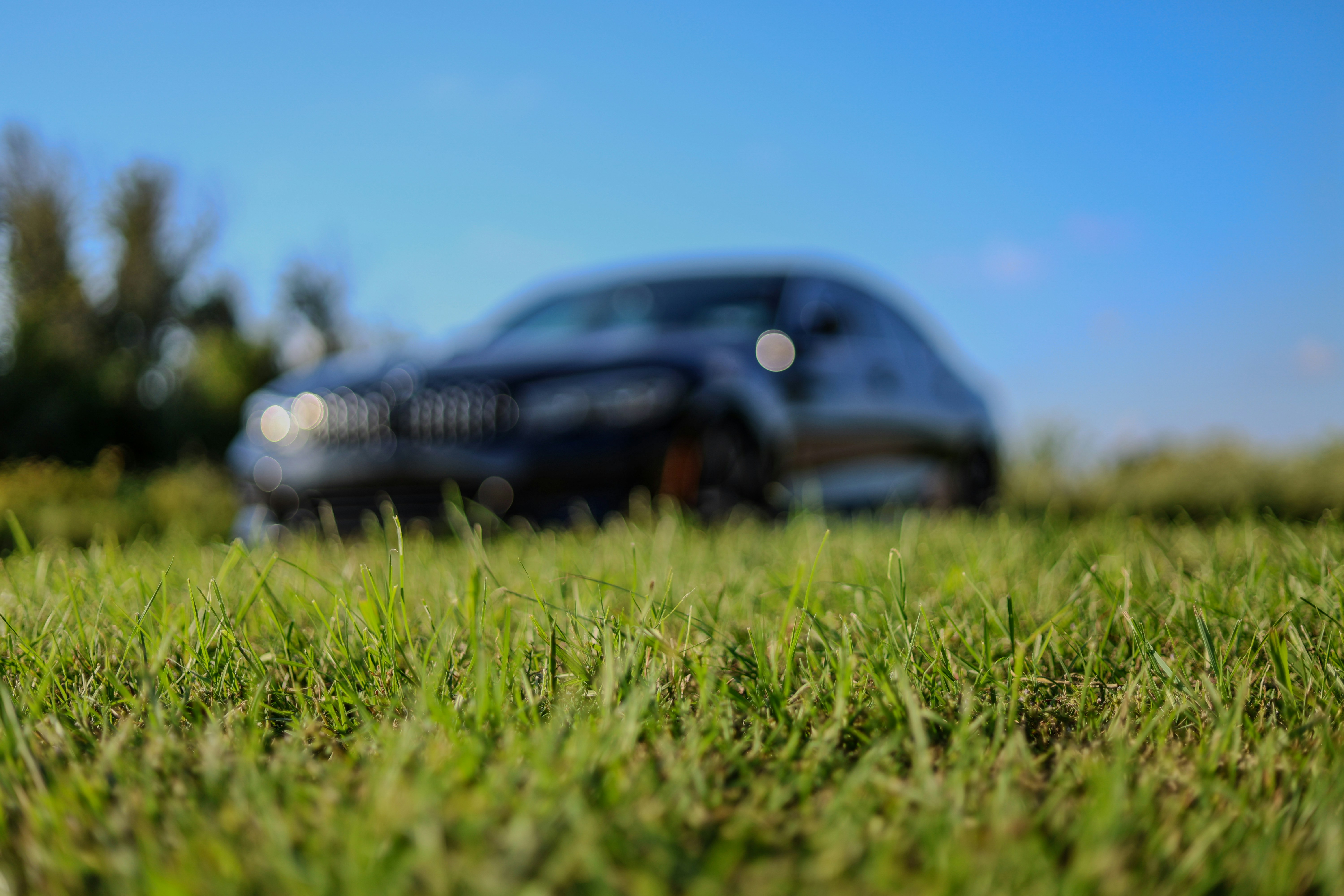 A blurry photo of a car parked in the grass